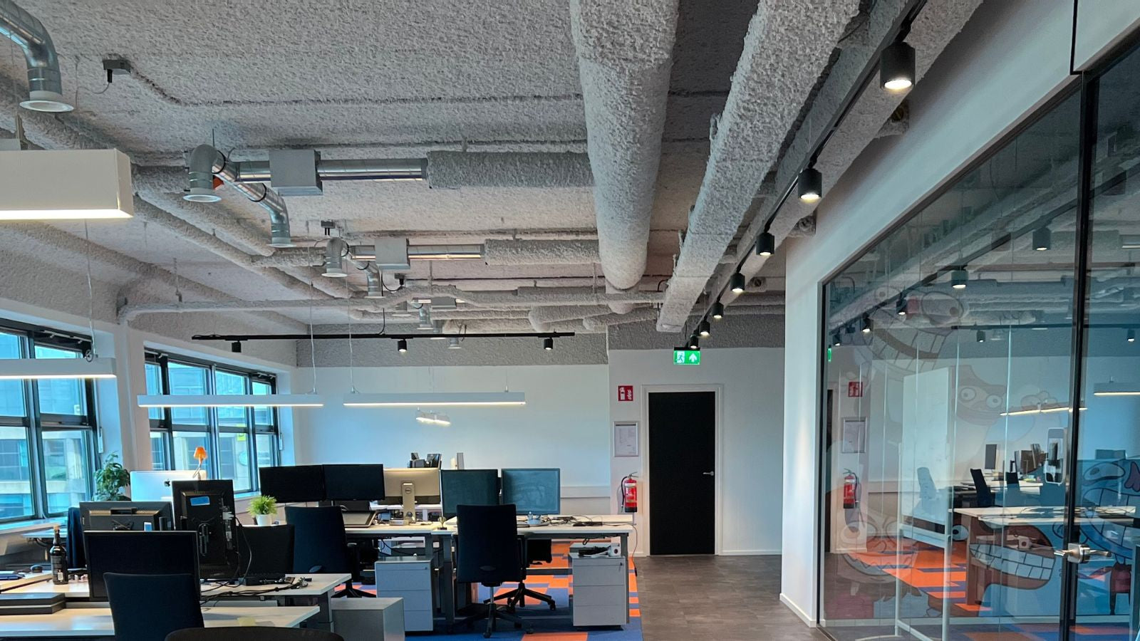 Akoestisch spuitplafond in moderne kantoorruimte